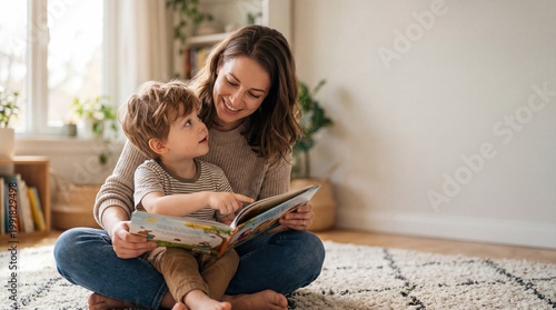 Happy mom and son reading picture book at home sitting on floor in living room family bonding time with child learning education concept for early childhood development at nursery