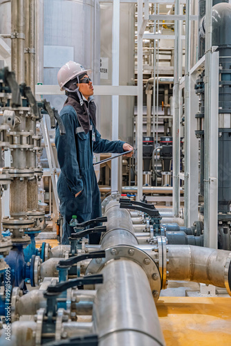 Male work inspection process valve control at the process area of the pipeline, flowing stainless steel chemicals in a factory