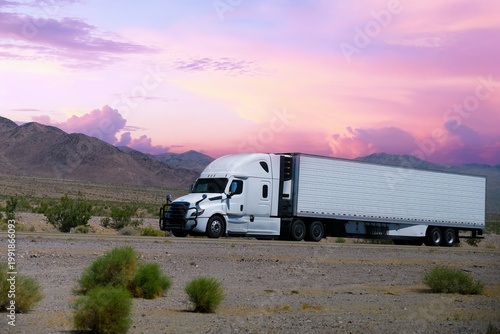 truck driving on highway through nature and mountains. Commercial vehicle transport for logistics and shipping.