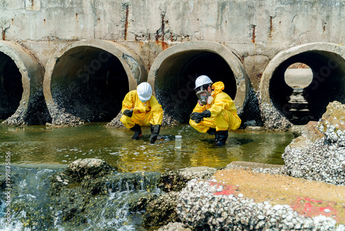 Workers conduct tests near water outlet in city during daytime for environmental assessment