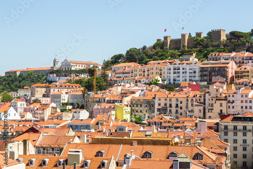 Lisbon, Portugal - 15 April 2024: View over the city center of Lisbon with historic fortress Castelo de Sao Jorge on a hill and houses with colorful facades underneath