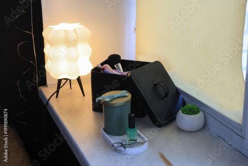 Obraz na płótnie Cozy vanity corner with a decorative lamp and makeup essentials organized neatly