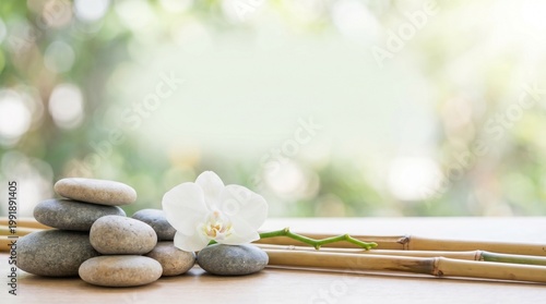 Relaxing scene with stacked stones, white orchid, and bamboo on a table outdoors