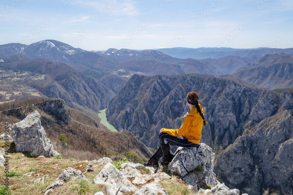 Fototapeta premium Girl in the mountains. Tara National Park, Serbia