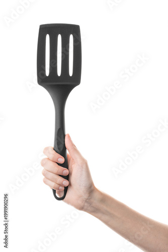 Ladle, spatula, kitchen utensils, in hand isolated on white background. Kitchen spatula on an isolated white background. Black plastic kitchen spatula. Kitchen utensil set.