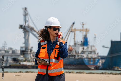 Foto Woman wears white hard hat and orange safety vest