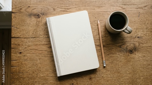 Blank notebook and coffee cup on a wooden surface