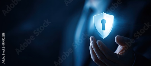 Glowing shield with keyhole floating above cupped hands, set against dark blue background