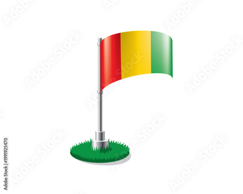 Guinean flag on a flagpole mounted on the grass