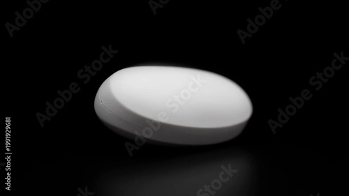 Pill in the darkness: A solitary, pristine pill, captured in sharp focus against a stark black expanse, embodies the essence of health and medication. 