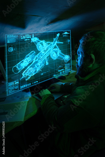 Fotografie Engineer using laptop viewing military aircraft blueprint hologram in dark workspace