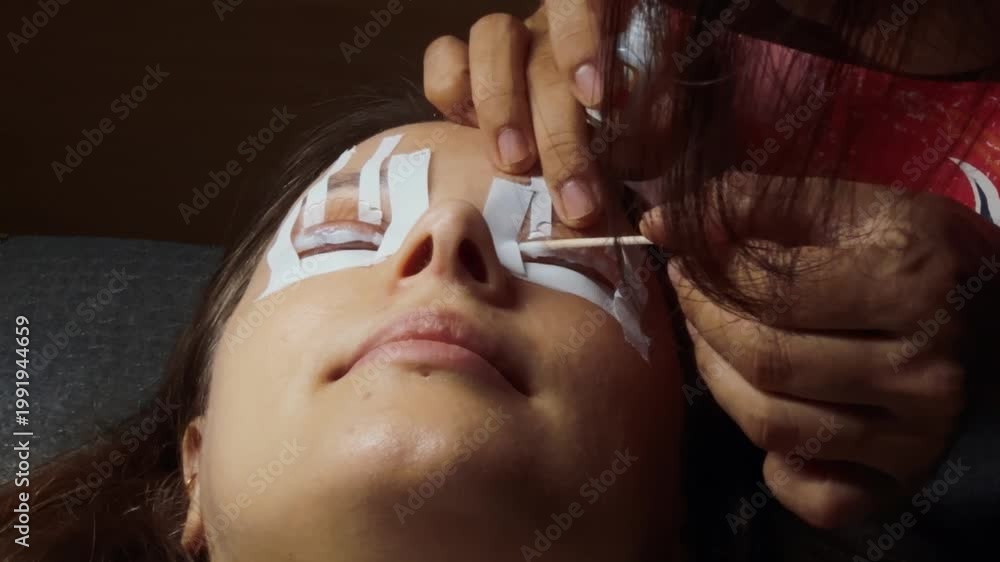 Receiving Lashes Cliente receiving a beauty treatment at a spa, with an esthetician ...
