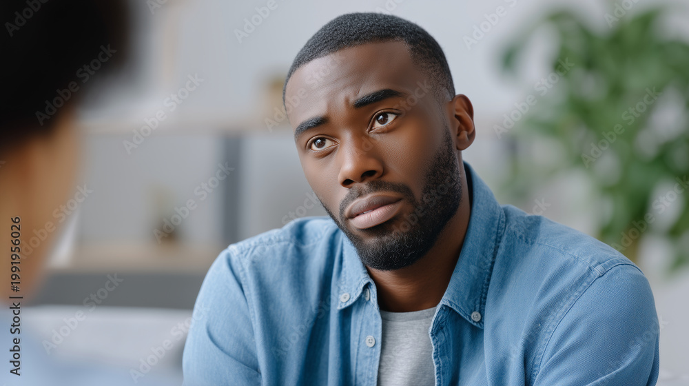 Obraz premium Faceless supervisor sitting in a casual office corner supporting an employee through a challenge, representing mentorship and psychological safety, soft natural light, indoor plant
