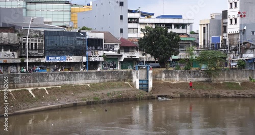 A murky river flowing along the outskirts of a residential area in Jakarta, Indonesia, on April 15, 2026.