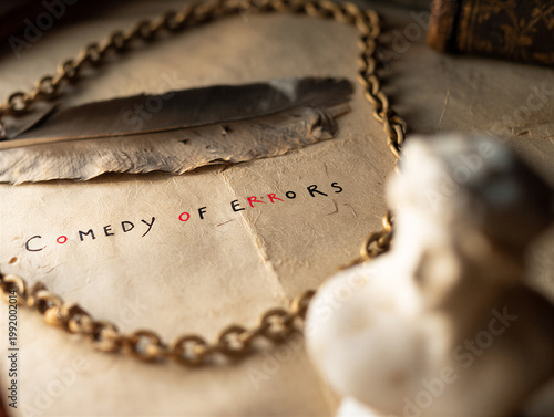 The shakspearian play Comedy of errors written onto parchment, illustrating the play with various items, Two sets of twins, a gold chain, parchment & quill, authentic shakspear scene