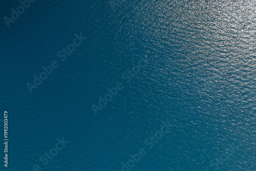 Aerial view of calm ocean surface with ripples and waves
