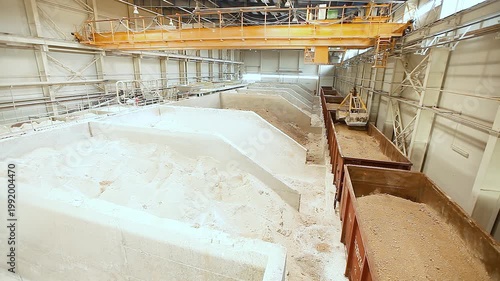 Unloading of railway wagons and storage of bulk materials in a warehouse. Sorting, loading and storage of bulk materials in a closed industrial warehouse.