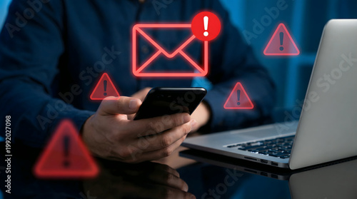 man holding phone with email notification and warning signs