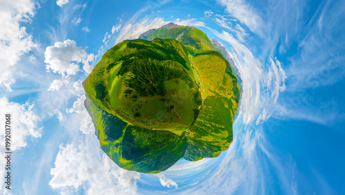 Obraz na płótnie Aerial little planet view of green mountains and valleys with clouds