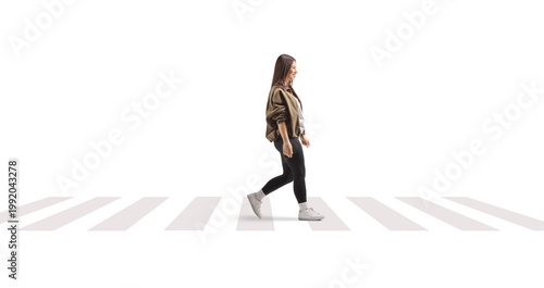 фотографія Young woman walking slowly at a zebra crossing
