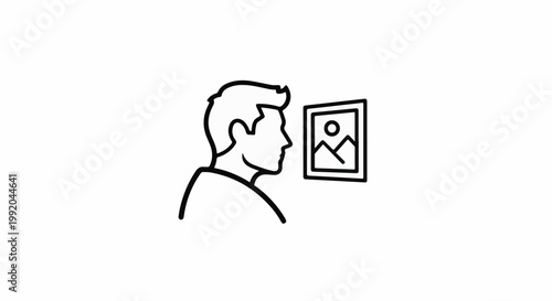 Person looking at a framed picture of a mountain landscape