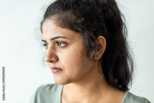 Canvas Print Thoughtful woman gazing sideways photo