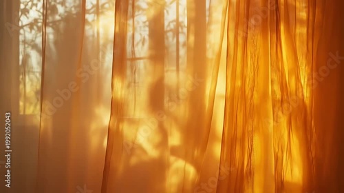 Golden fabric blowing in sunlight with blurred tree shadows background