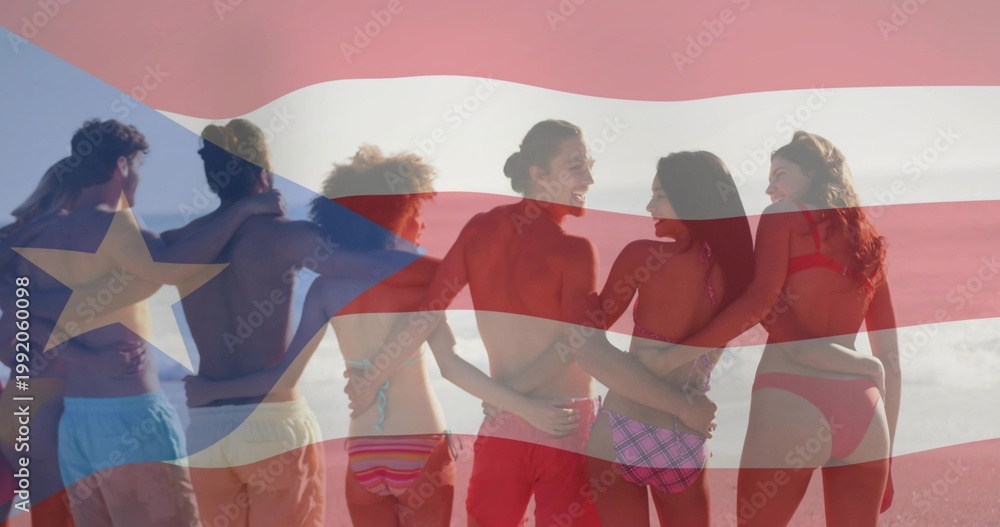 Fototapeta premium Standing eight adults linking arms on sandy shore, wearing swimwear under Puerto Rican flag overlay