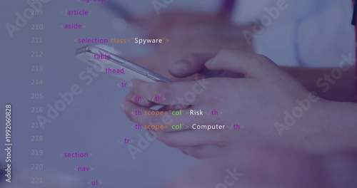 Holding pair of hands tapping smartphone at desk, with code overlay and short-sleeve shirt