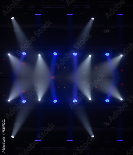 An empty stage of the theater, lit by spotlights and smoke before the performance