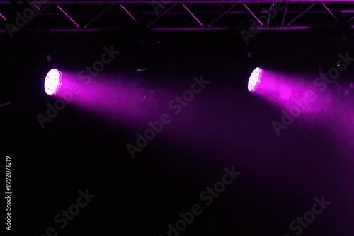 An empty stage of the theater, lit by spotlights and smoke before the performance