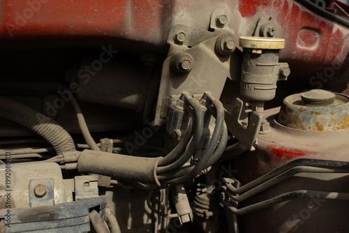 A close-up, gritty shot of an internal combustion engine's upper components.