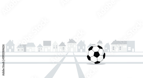 A classic black and white patterned soccer ball sits prominently on a light gray street surface with a faint silhouette of suburban houses in the distance.