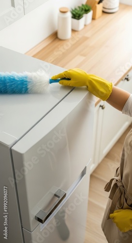 A woman cleaning dust accumulated in the refrigerator