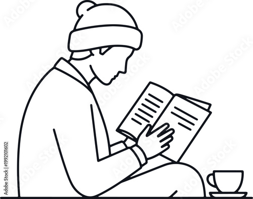 Person reading book with cup of tea, cozy indoors, winter comfort.