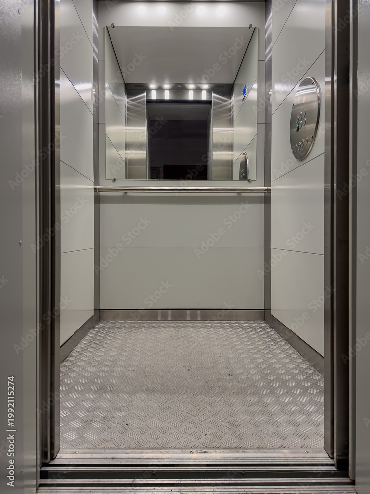 Fototapeta premium Interior View of a Modern Elevator with Sleek Design, Reflective Surfaces, and Illuminated Environment Capturing the Essence of Contemporary Architecture