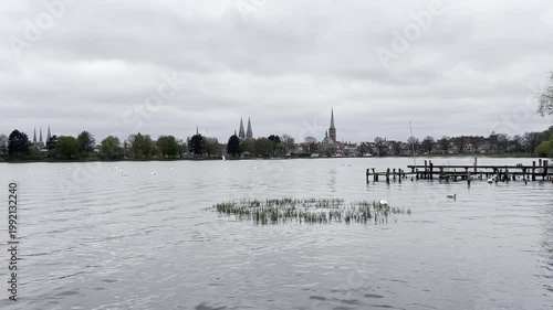 View of the old city of Luebeck seen from the Wakenitz River on an overcast day