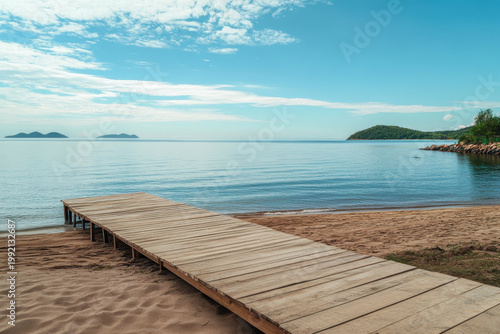 Wooden pier stretching into calm blue lake on sunny day