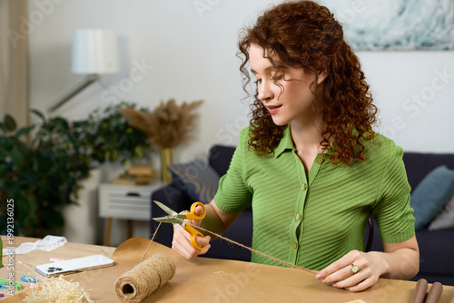 Obraz na płótnie Creating handmade crafts in a cozy living room with natural light and cheerful p