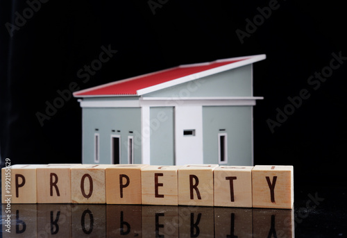 Property writing and miniature houses. Real estate concept