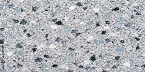 A gray textured stone wall featuring a rough granite pattern and macro marble surface details creates a cold grunge material design