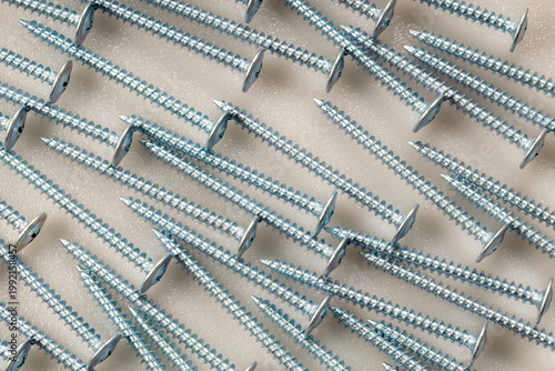 Metal zinc screws in semi circle composition on white background with text area