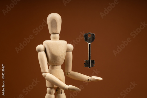 Artist doll with outstretched arm under floating door key, access and liberation theme