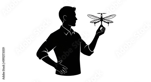 Silhouette of a person holding a bionic dragonfly-like drone for tech innovation