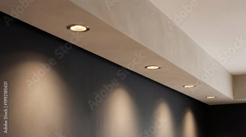 Recessed Ceiling Lights Illuminating Dark Wall Surface.