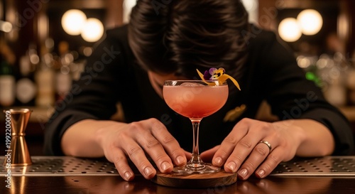 Elegant Pink Martini Cocktail Garnished With A Flower On A Wooden Coaster In Bar