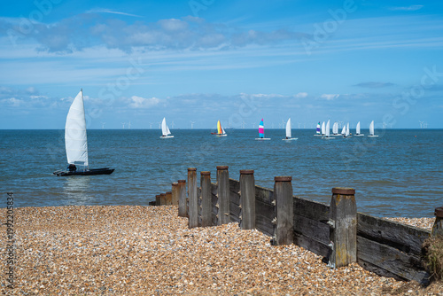 Quadro su tela Catamaran dinghies racing on Tankerton Beach in Whitstable, Kent UK