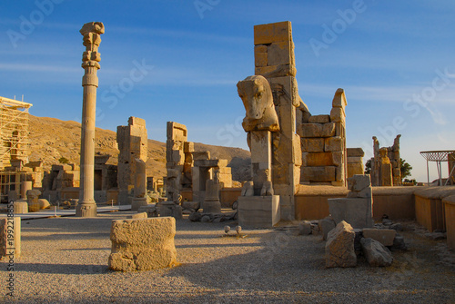 Apadana columns and monumental gates with sculpture of a two-headed horse in the ancient city of Persepolis in Iran