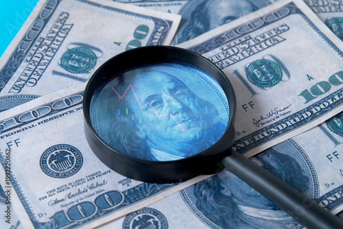A  magnifying glass on 100 dollar banknote for design.
