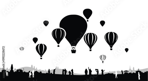 Hot air balloons float gracefully above a crowd of people in this silhouette scene.